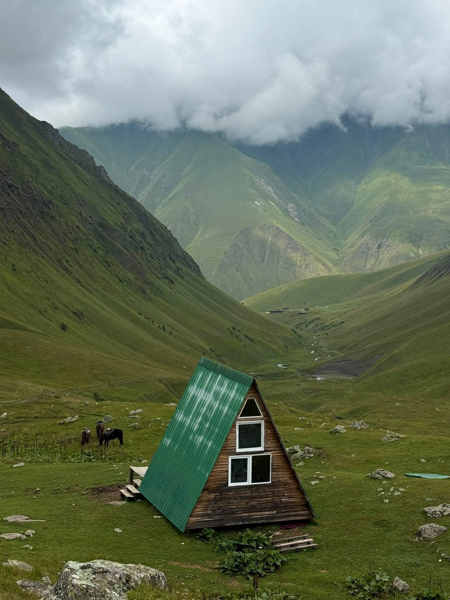 A view from Chaukhi Lake of the rolling hills of Juta Valley